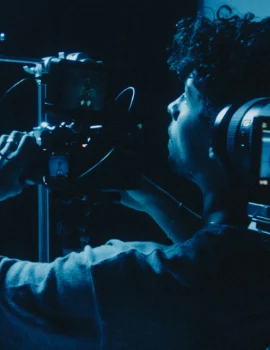 Reilin looking through a camera at a production