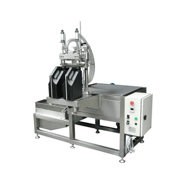 A side view of the 2-head volumetric bottle filler, with bottles on the conveyor.
