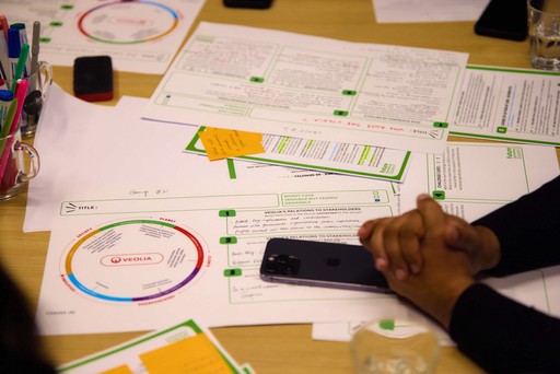 Close-up of a dark green leaf showing its textured surface and central vein against a muted background.