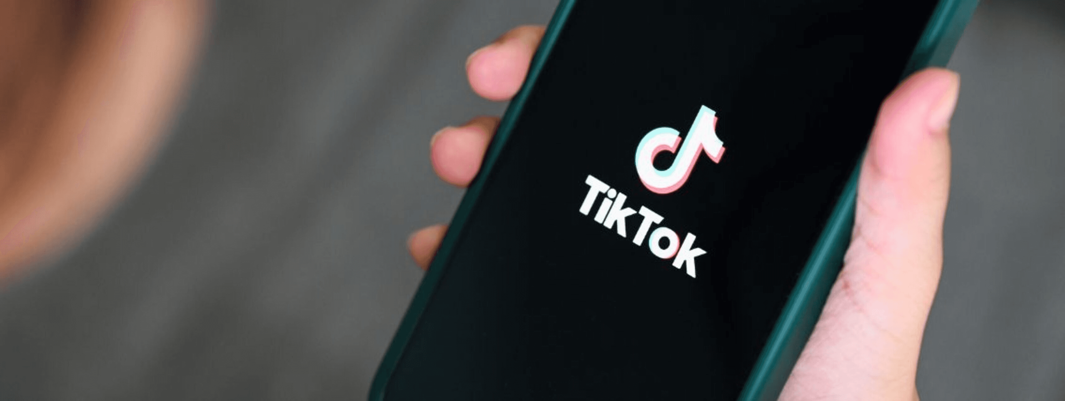 Person holding smartphone with TikTok logo - Best Content Strategy TikTok