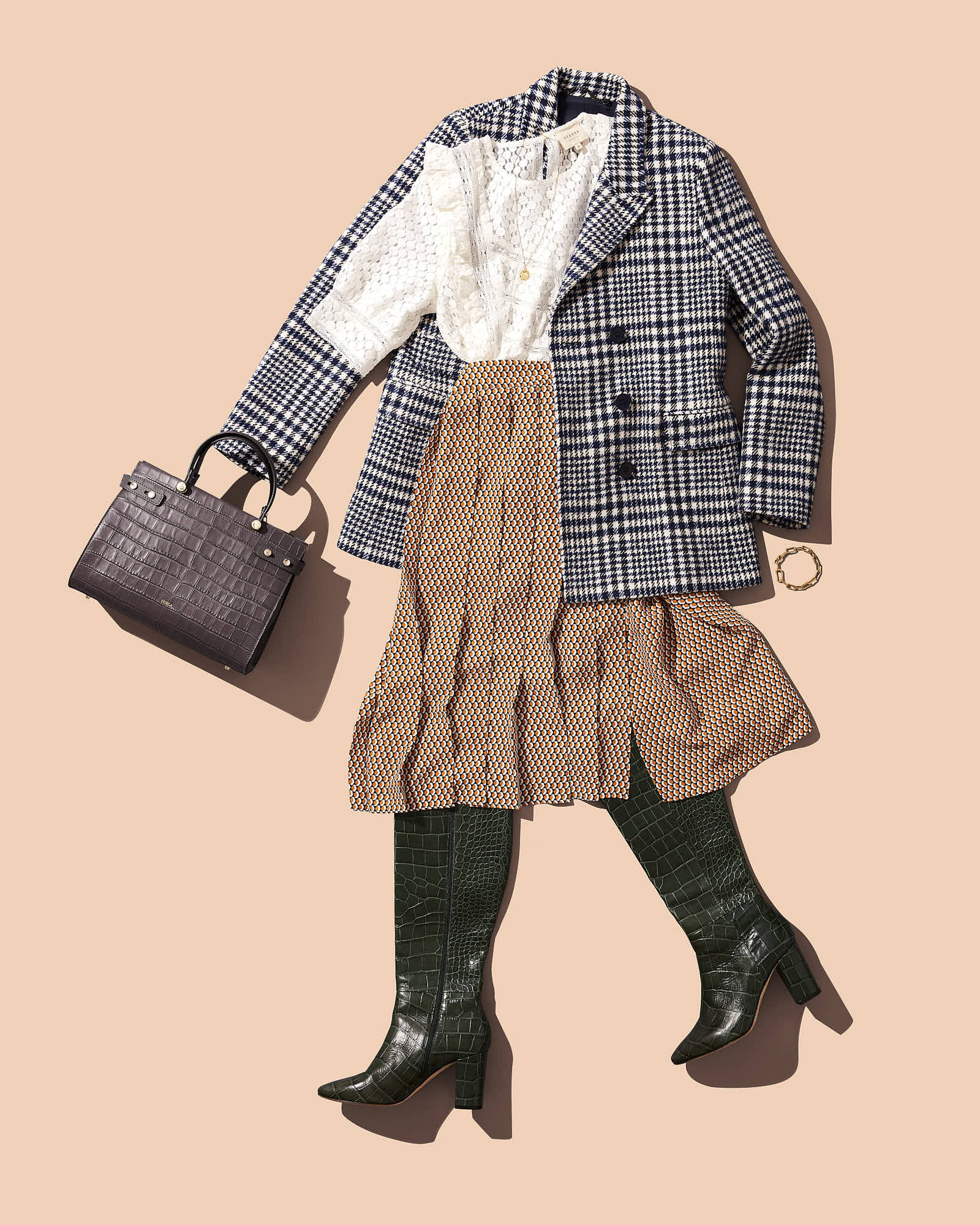 Fashionable fall outfit with plaid blazer, textured white blouse, patterned skirt, green boots, and crocodile handbag.