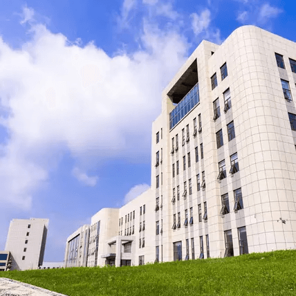 Modern, light-colored corporate buildings with numerous windows under a bright blue sky, symbolizing Jinyi Food's.