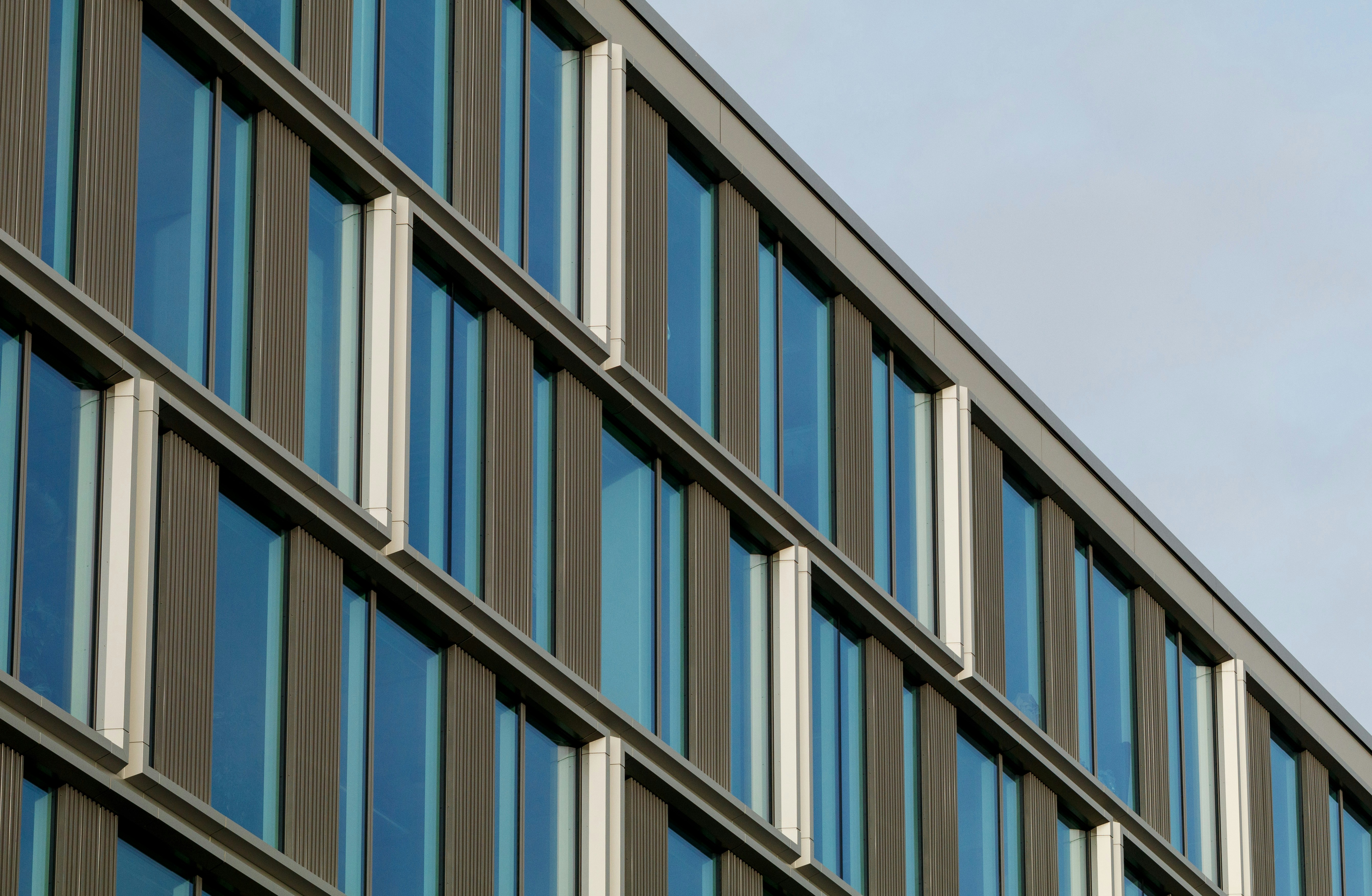 Low-angle view of modern high-rise buildings under a clear sky