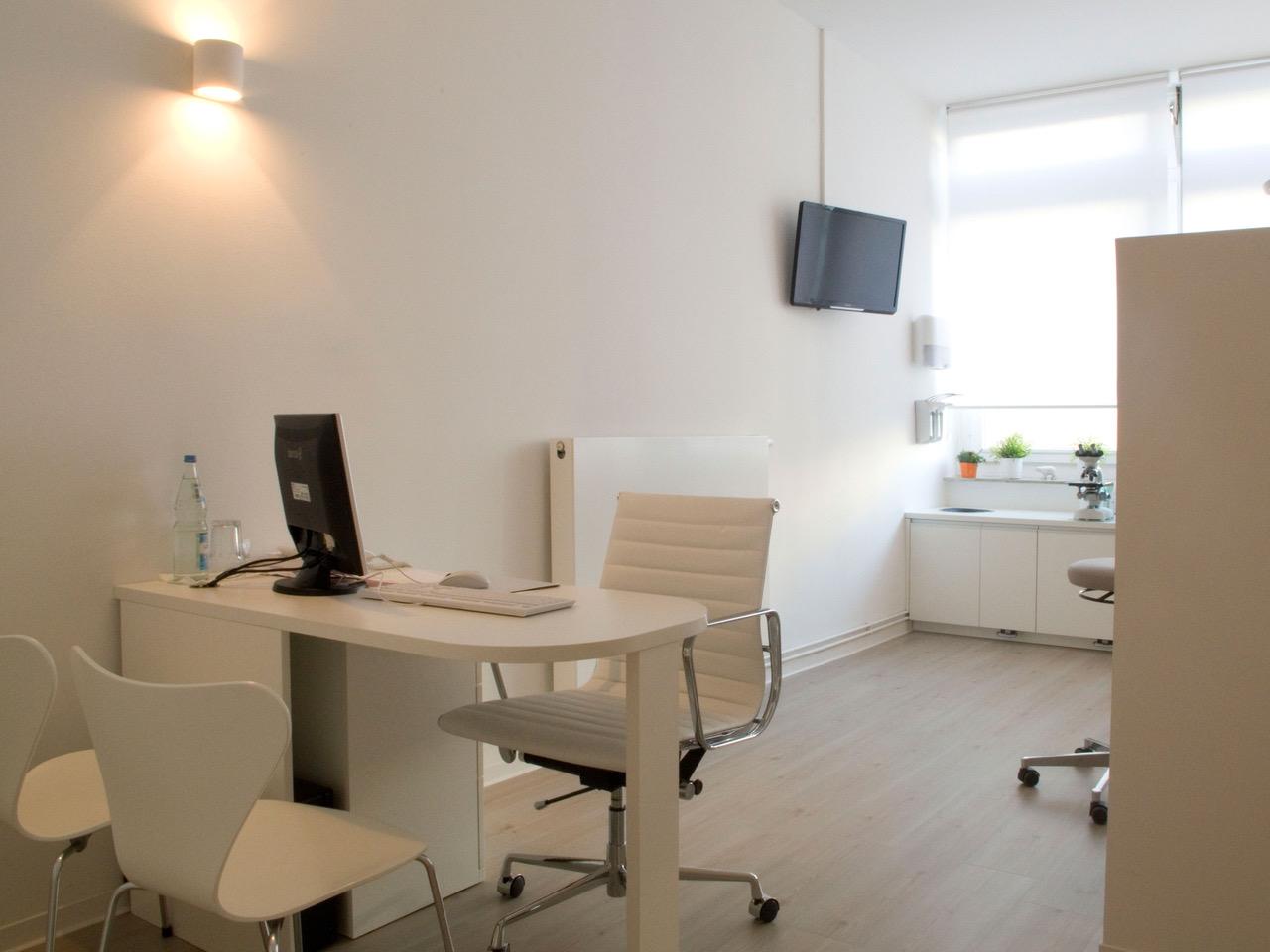 a pregnant woman laying on a bed covered in a blanket