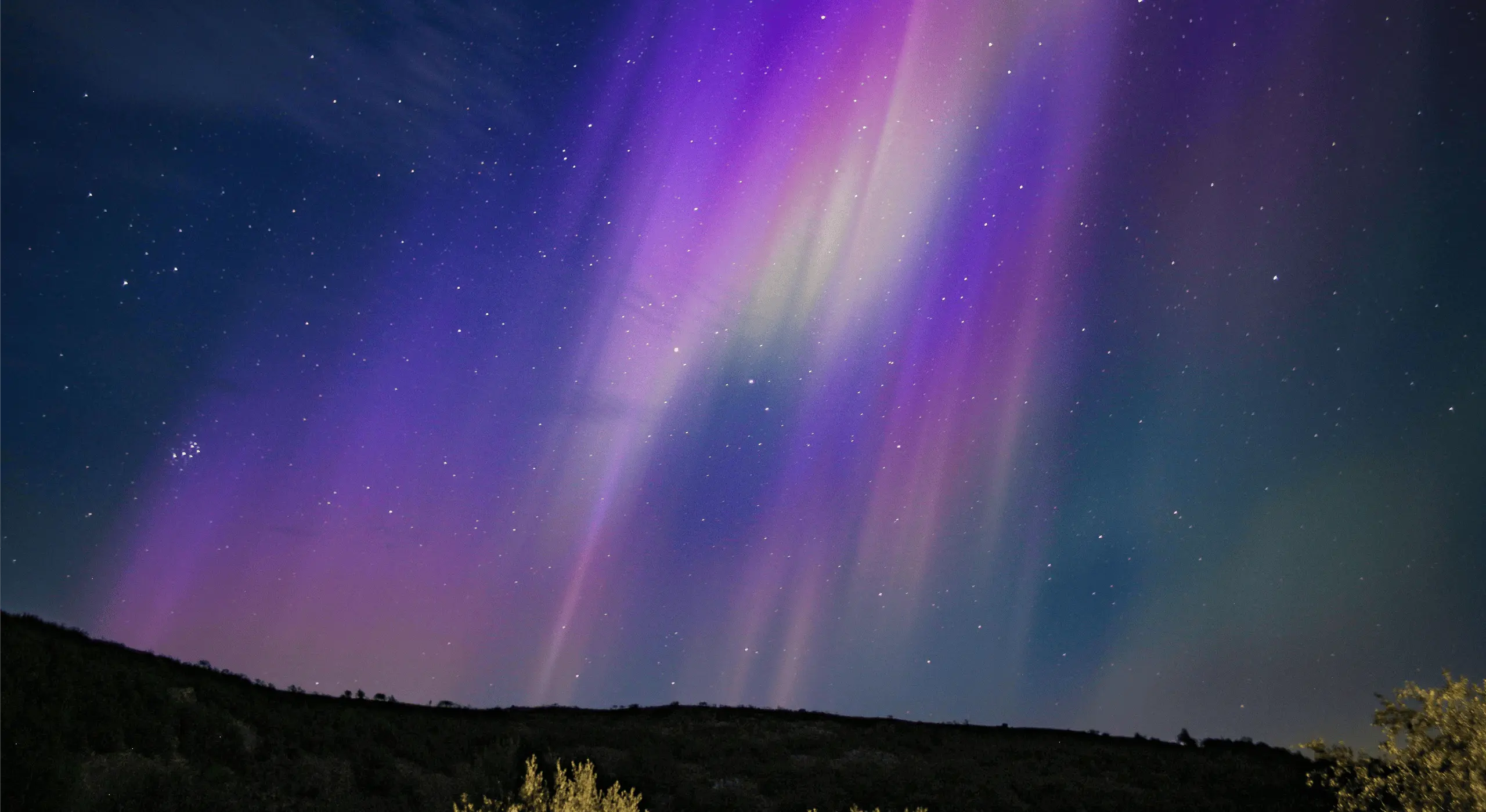 display of the Aurora Borealis over a remote landscape