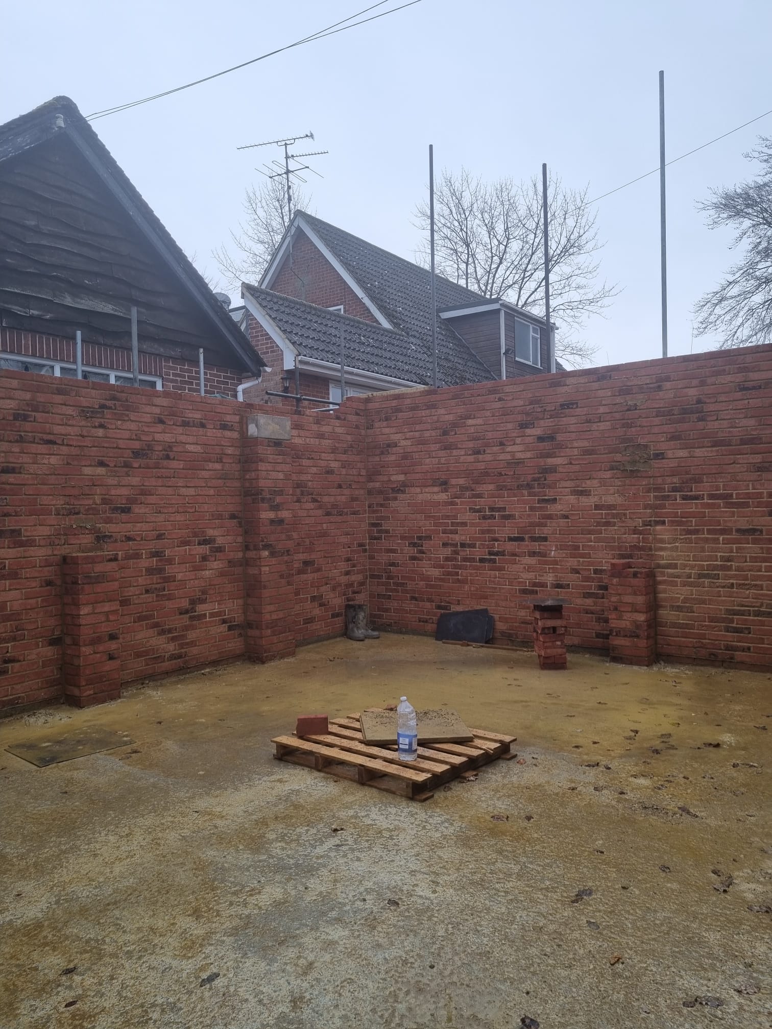 A close up of a brick wall with no mortar