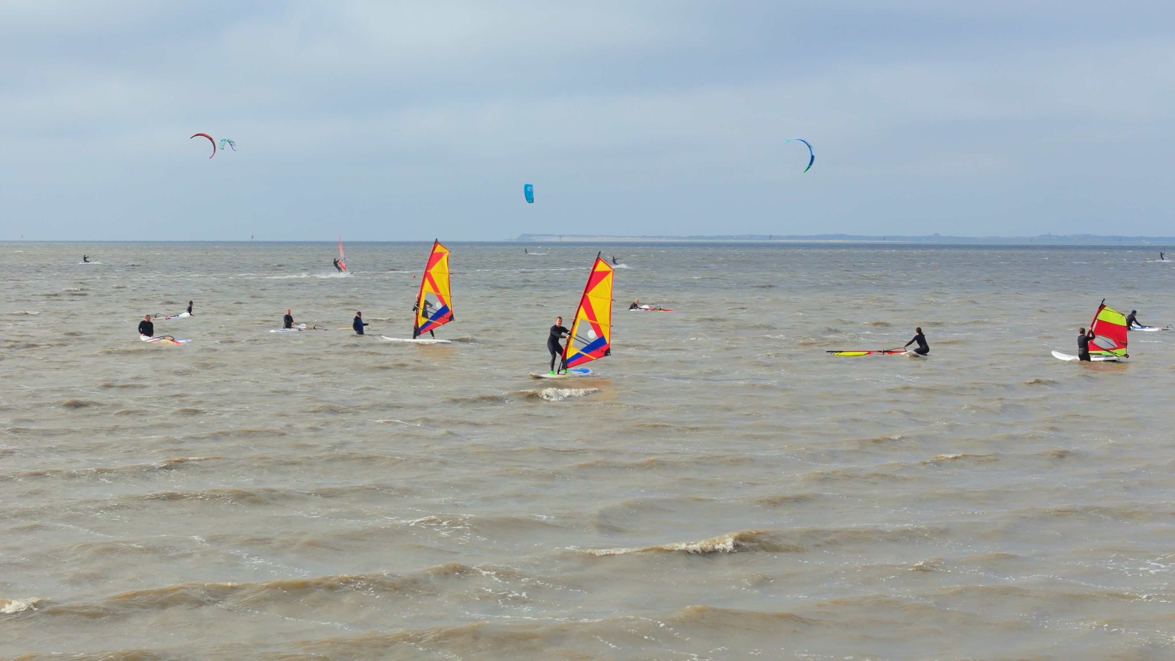 A person stands on a street corner at night.