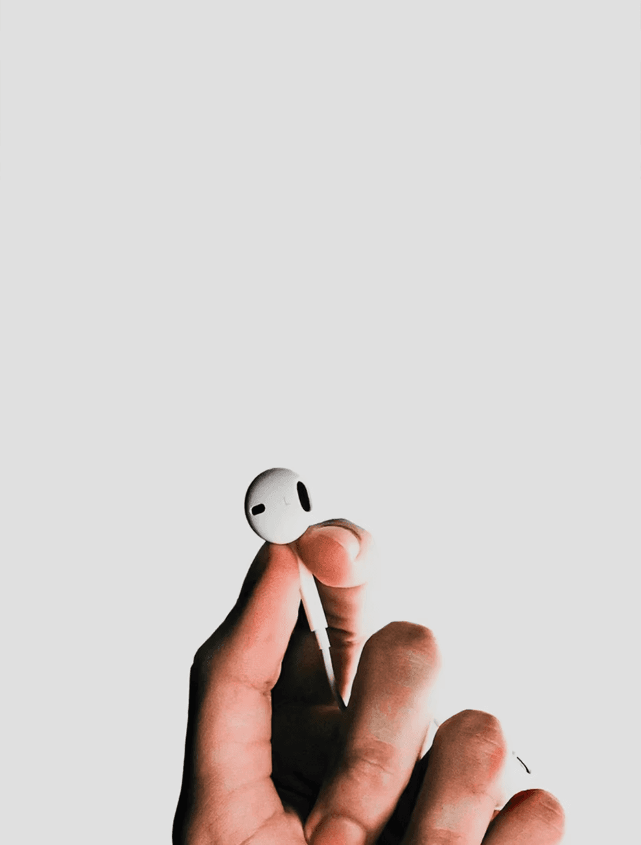 person holding Apple EarPods