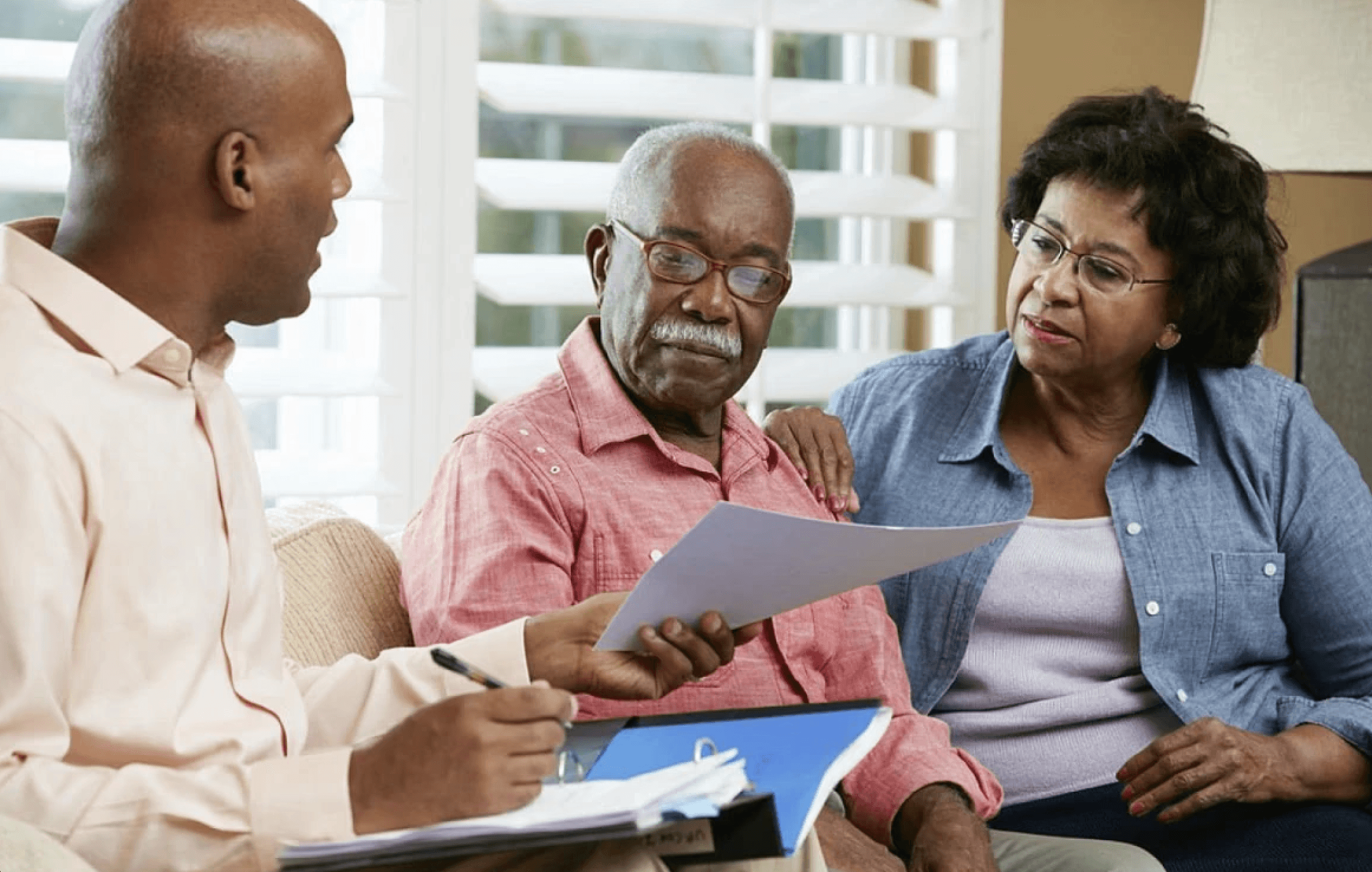 older couple talking to a younger man with documents in his lap
