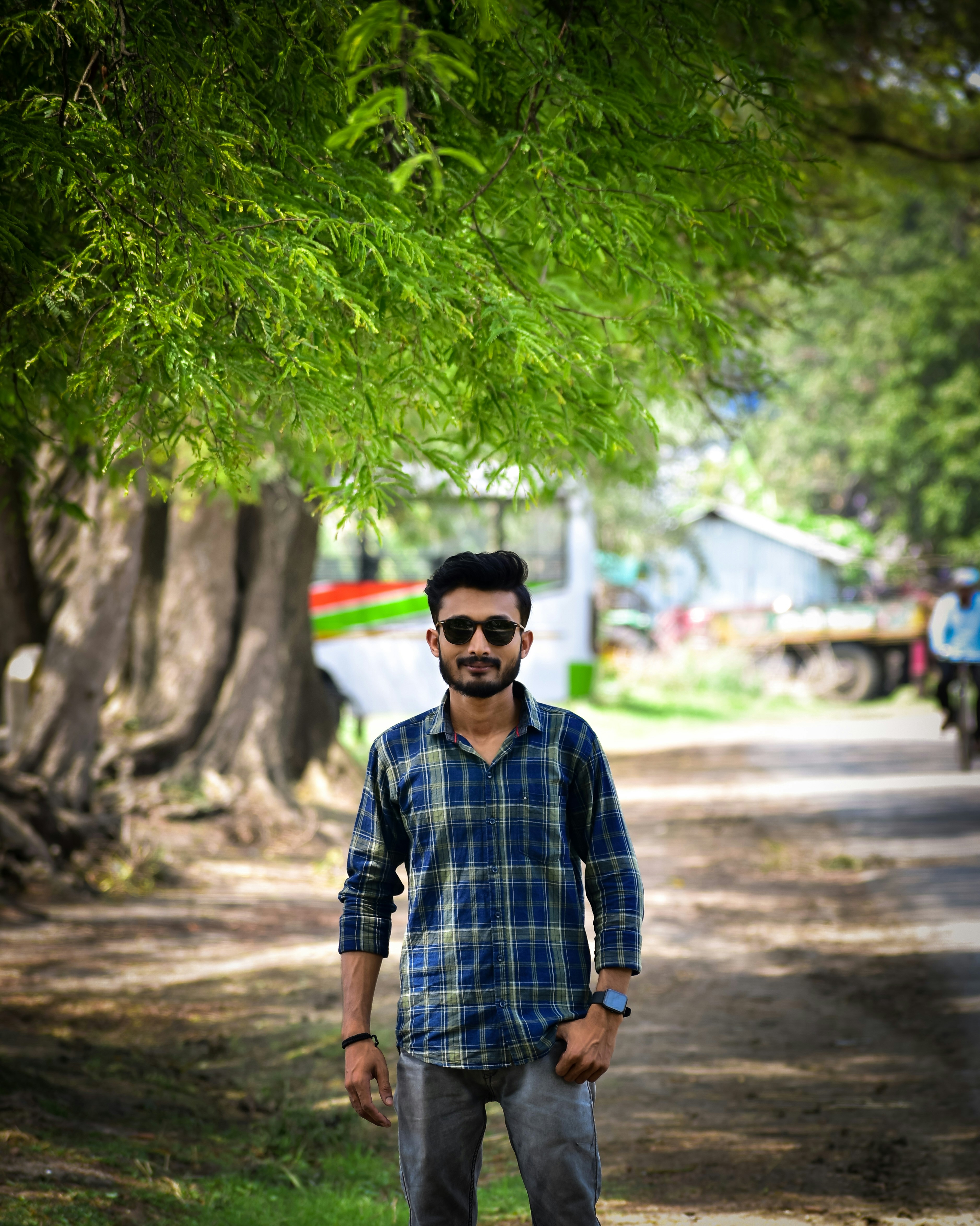 A man standing in the middle of a dirt road