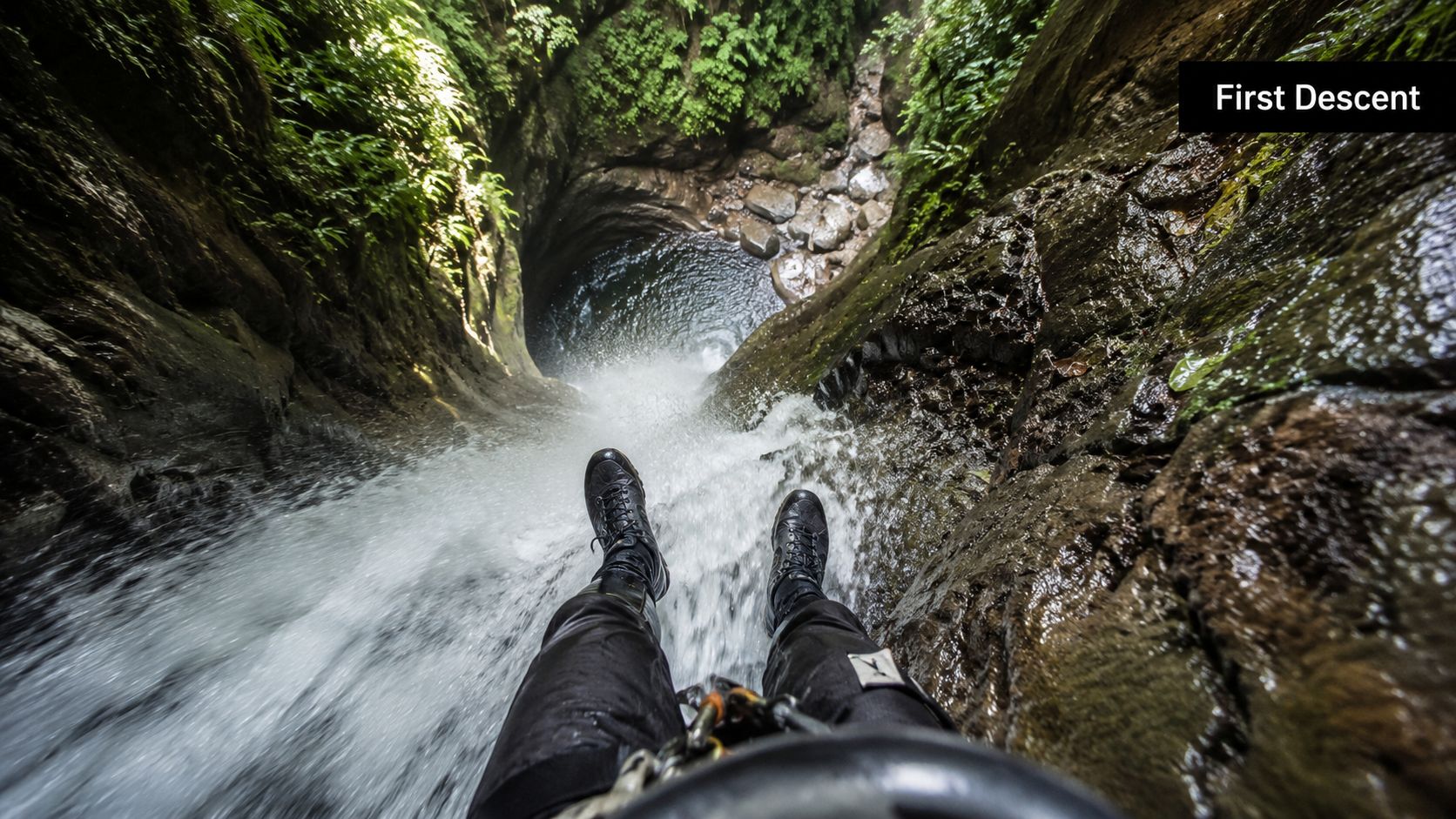 A person rappelling down a tall waterfall into a deep canyon pool in Costa Rica.