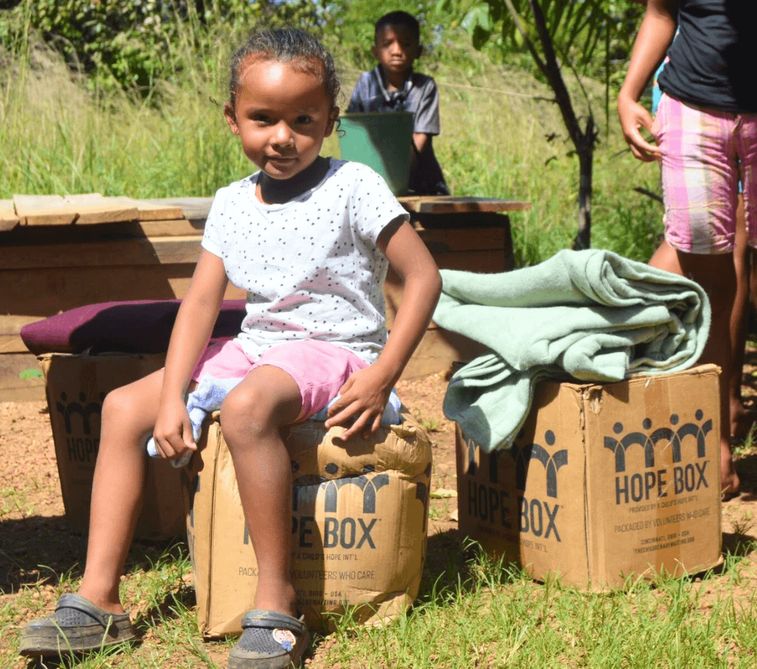 Young child sitting on Hope Box