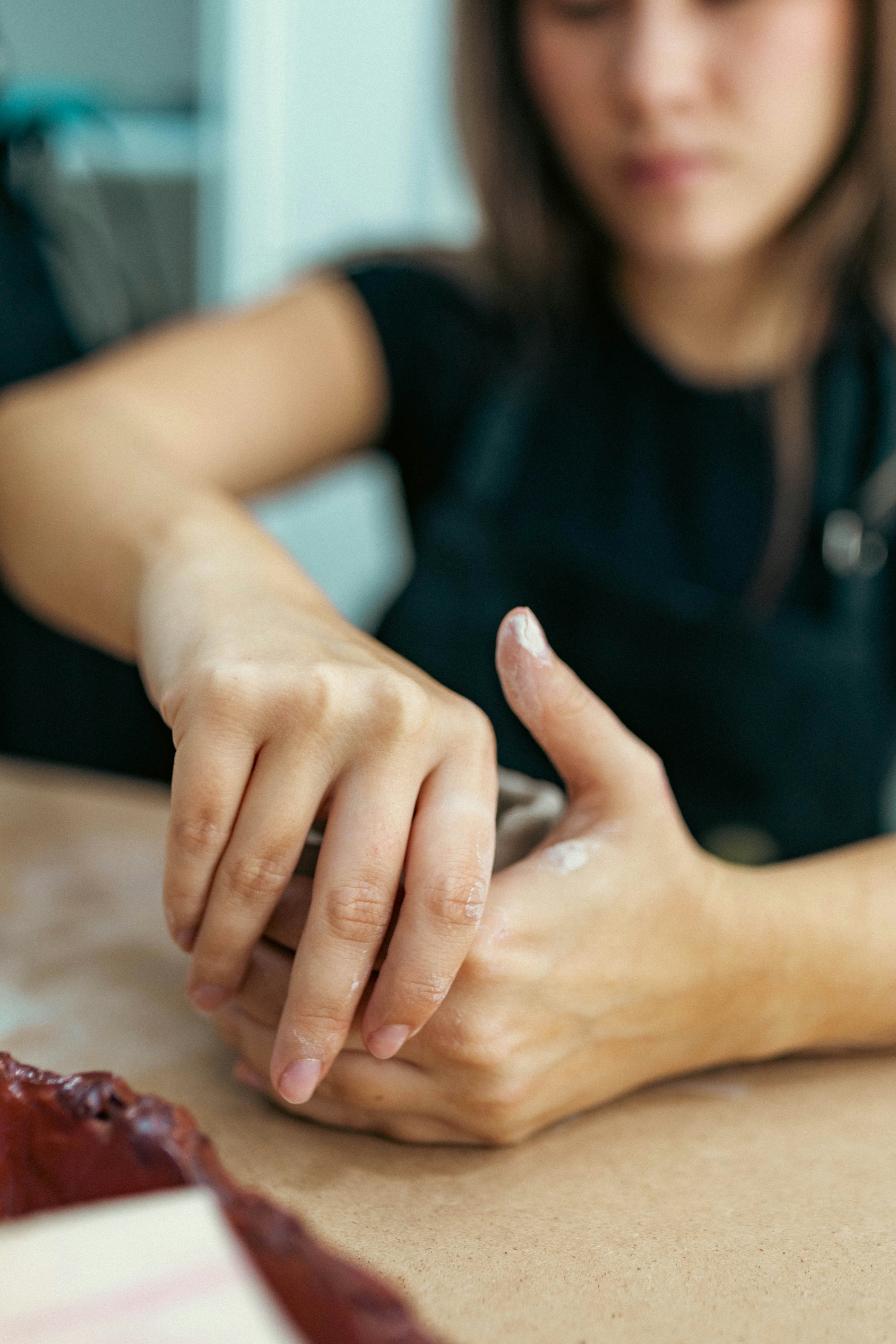 A woman sitting at a table using a cell phone