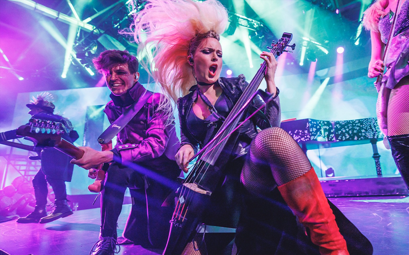 Musicians performing energetically on stage with vibrant lighting at WAH event.