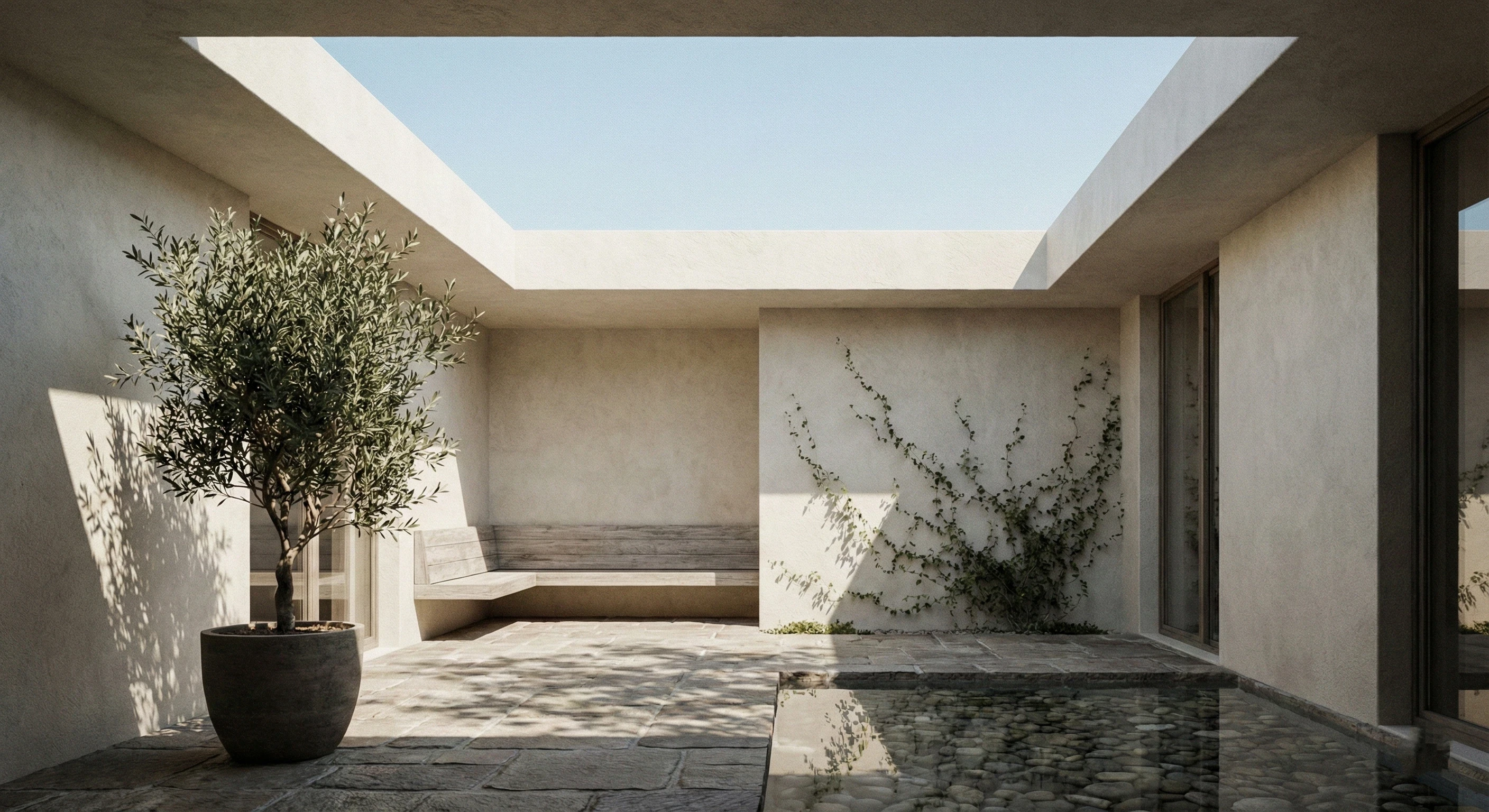Modern residential courtyard interior, open to sky, natural daylight illuminating walls and floors