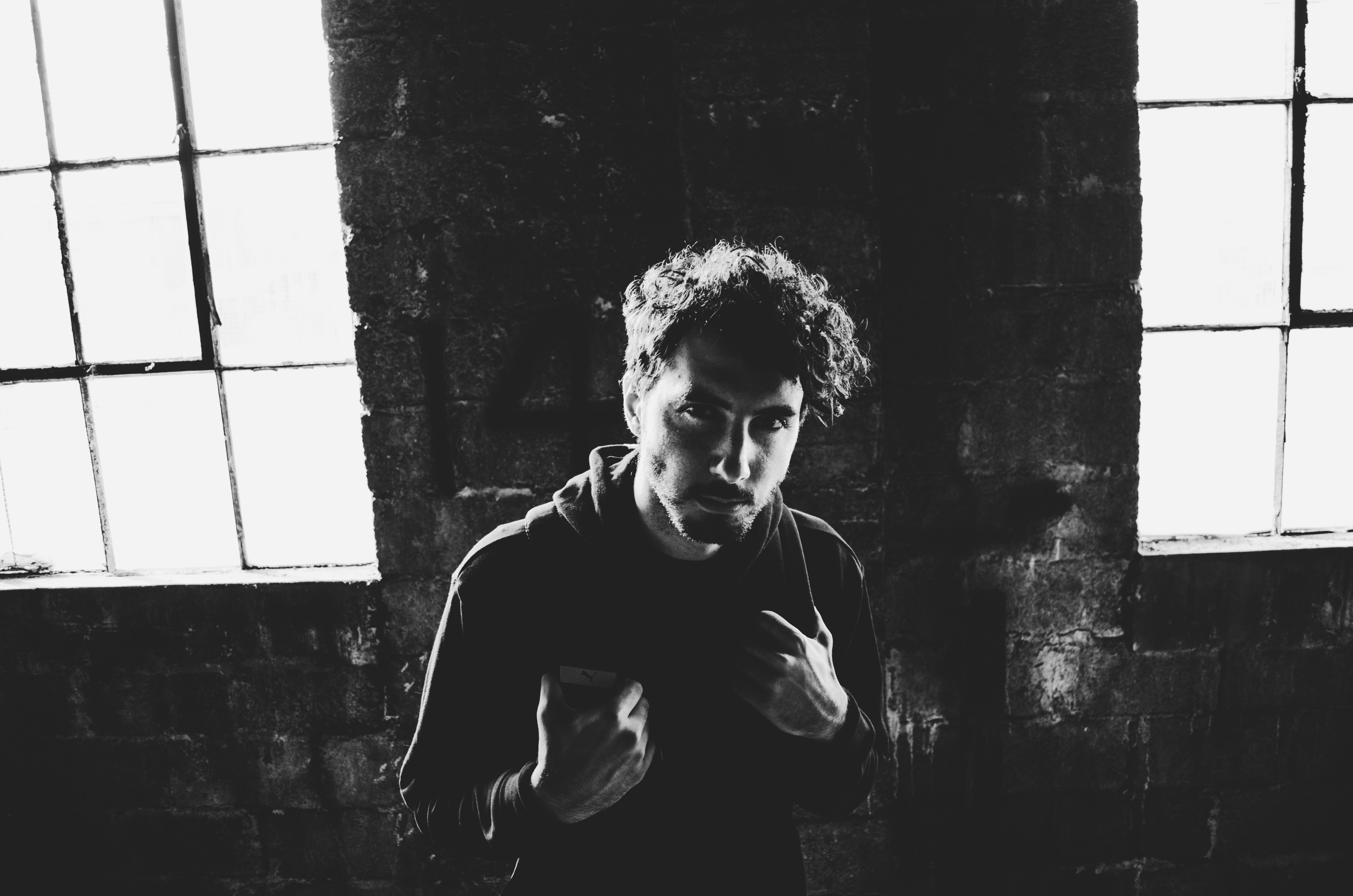 grayscale photo of man in black and white hoodie