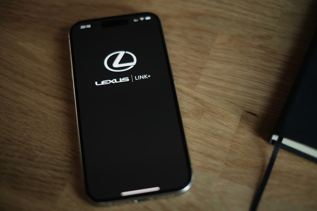 A cell phone sitting on top of a wooden table