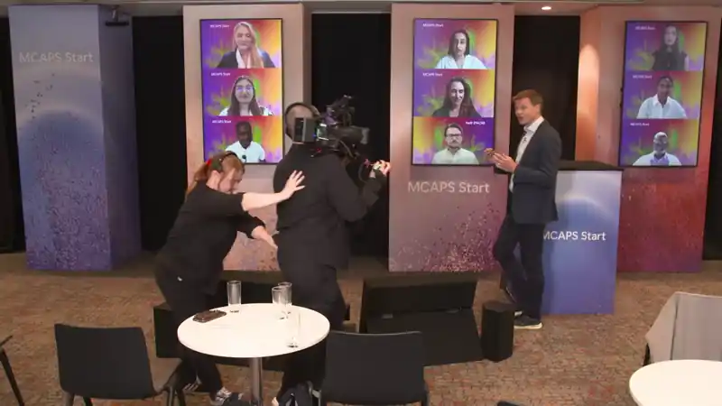 	•	Live event video capturing a presenter moving through a studio as production cameras follow in real time.