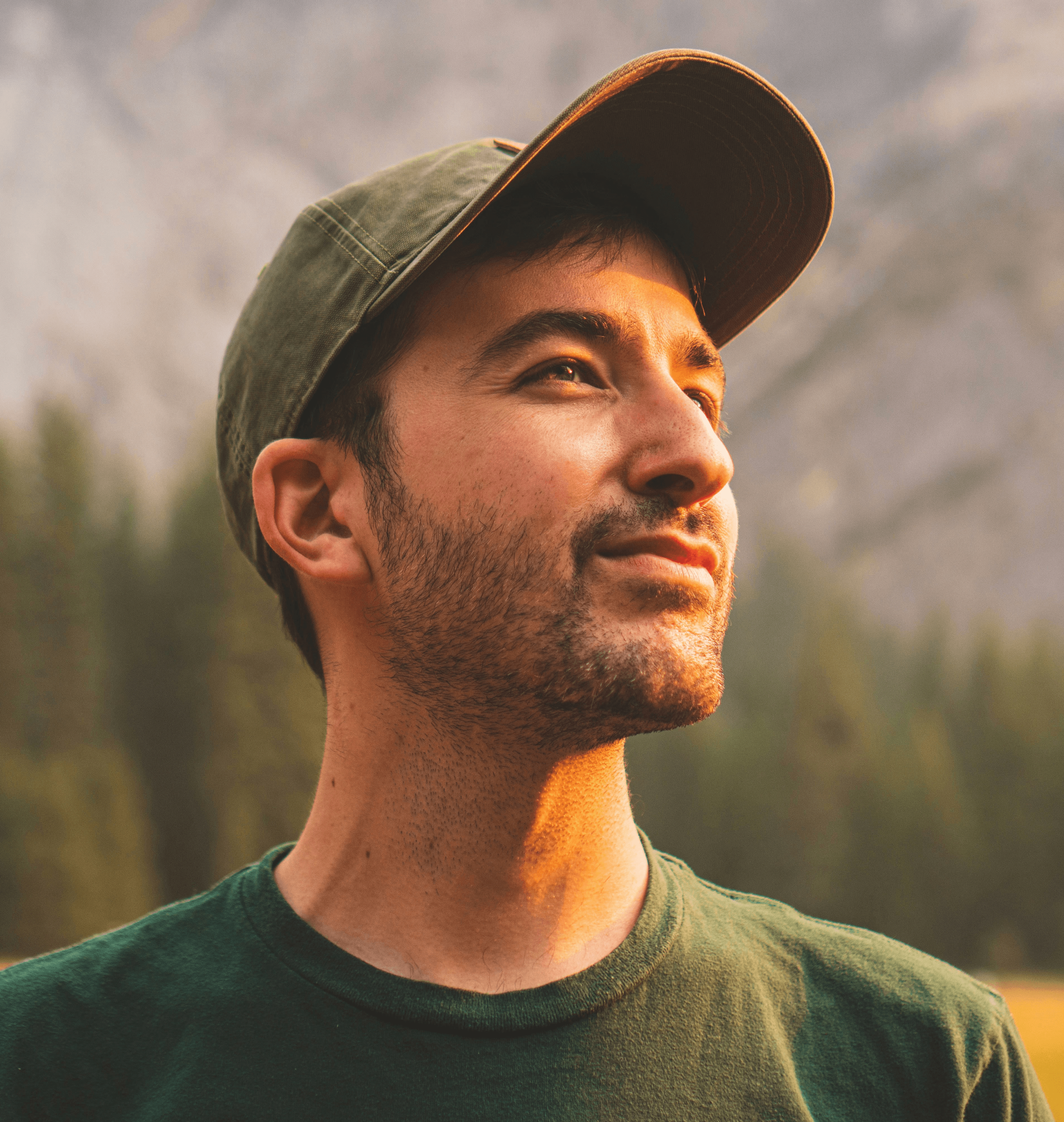 man in green crew neck shirt and black hat