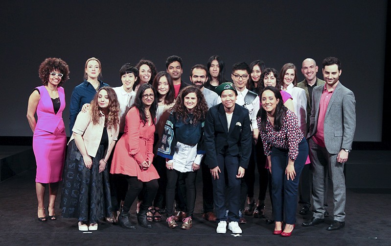 A photo of a group of people standing on a stage.