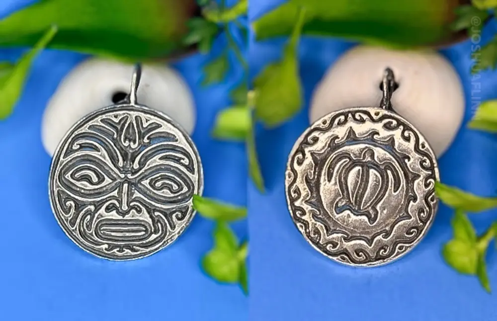 photograph of a cast silver pendant of a polynesian tribal face and turtle front and back