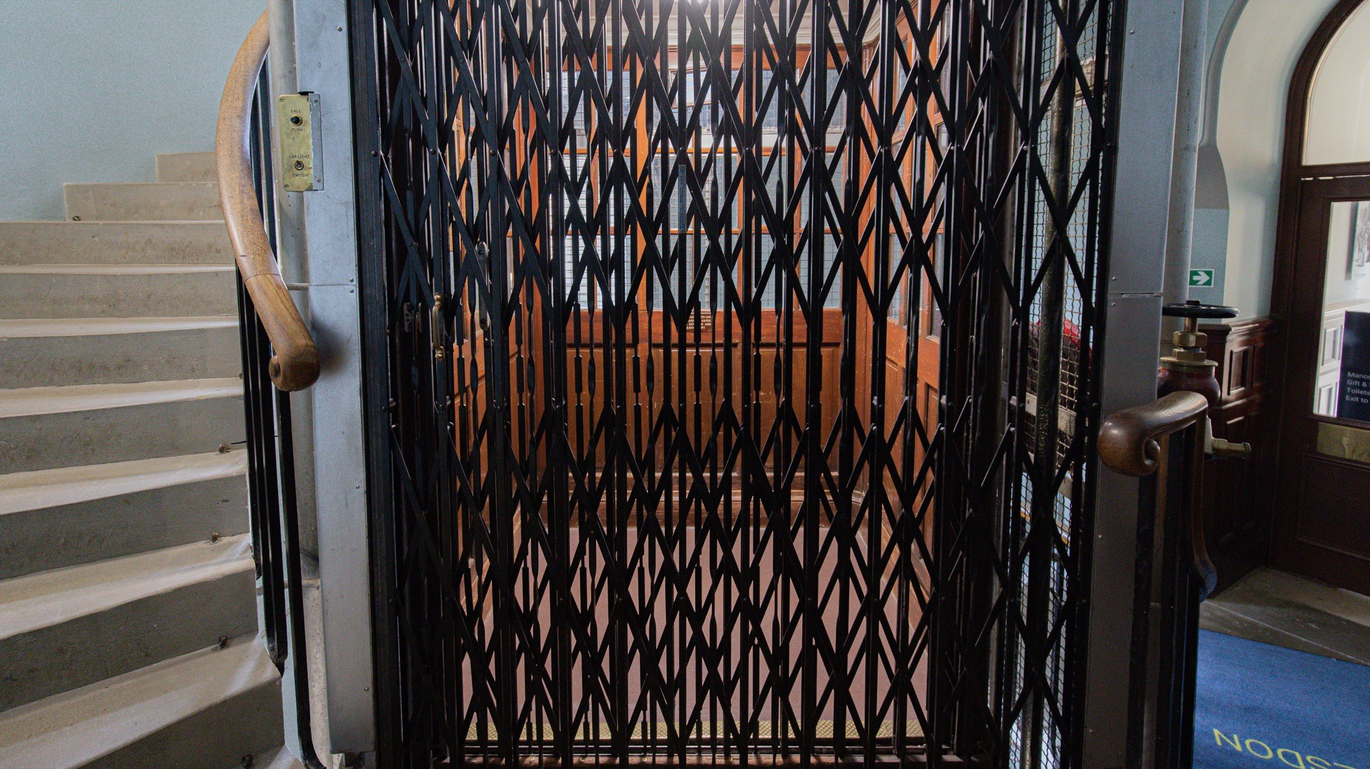 Two classic volkswagen beetles, one green, one cream.