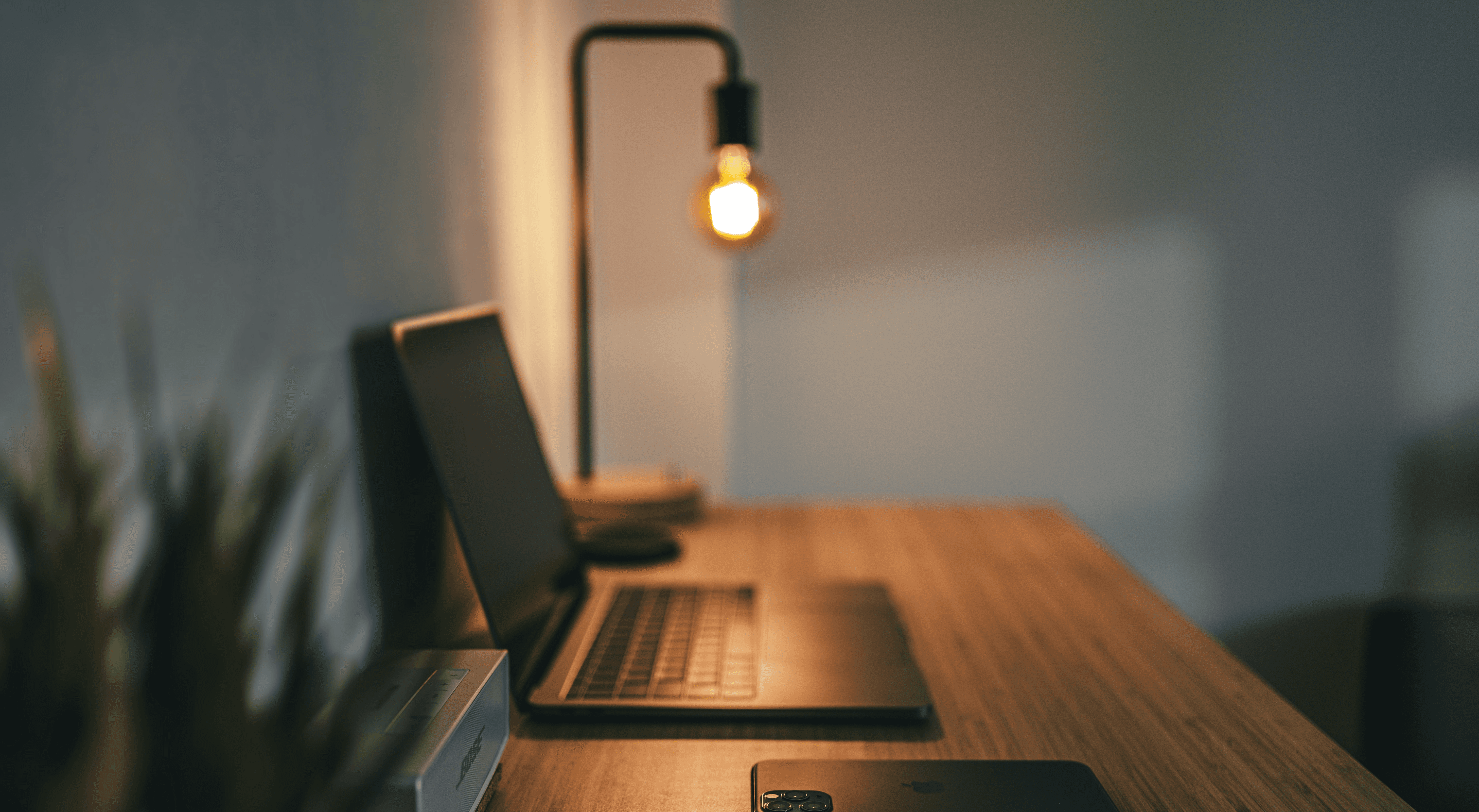 black laptop computer on brown wooden table