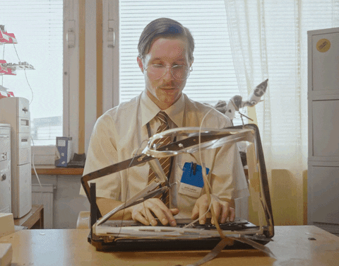 A man typing with a classic type machine