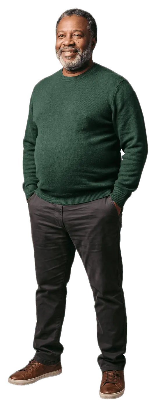 Smiling man in a green sweater standing with his hands in his pockets