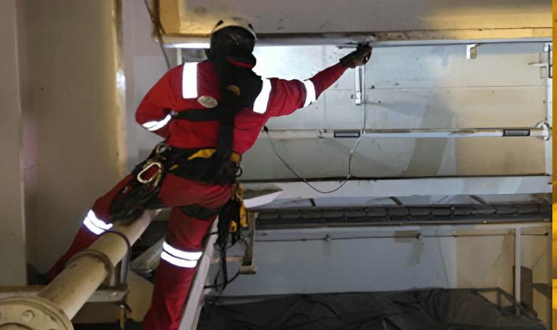Rope access technician performing ACFM weld inspection on offshore structure in the UAE