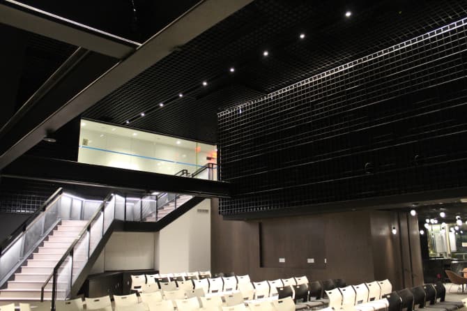 A staircase with small ceiling lights