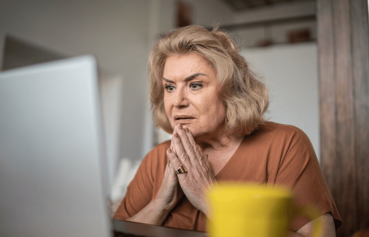 worried matured woman infront of laptop