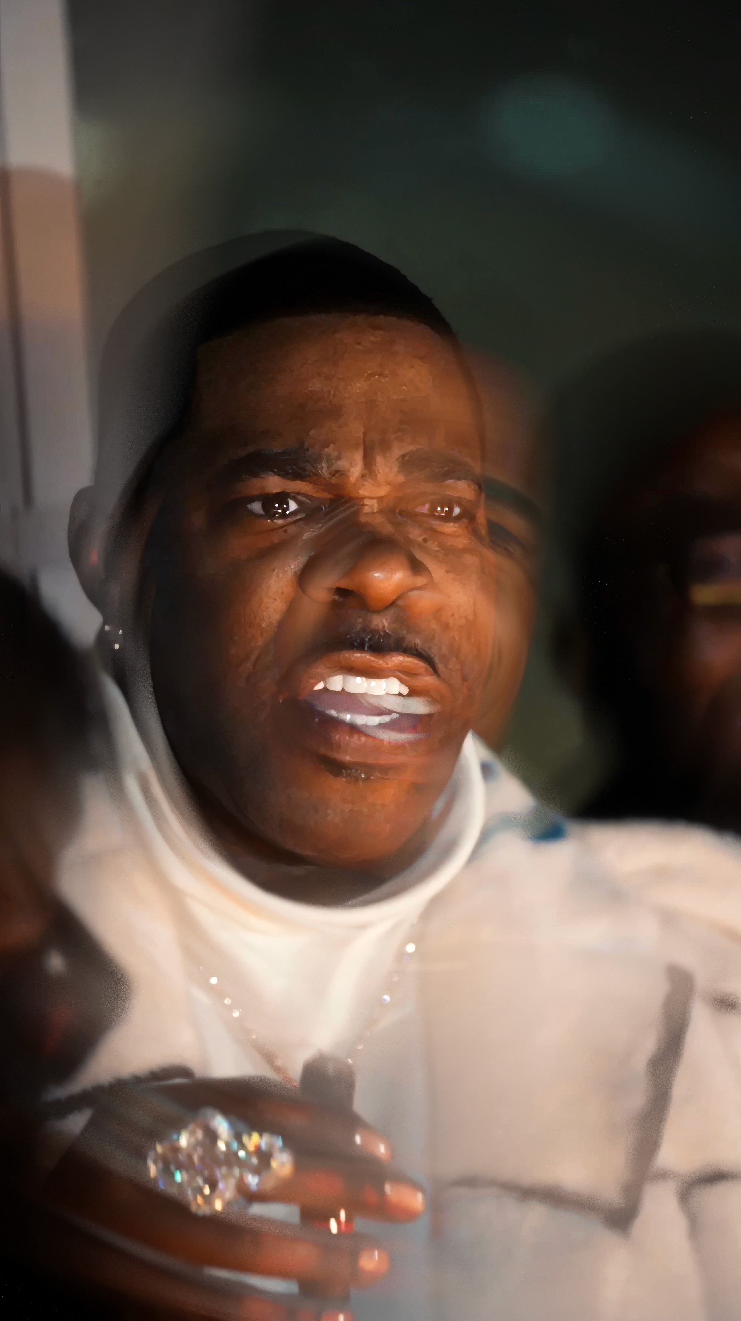 Dancer in black outfit with arms raised, arching backwards