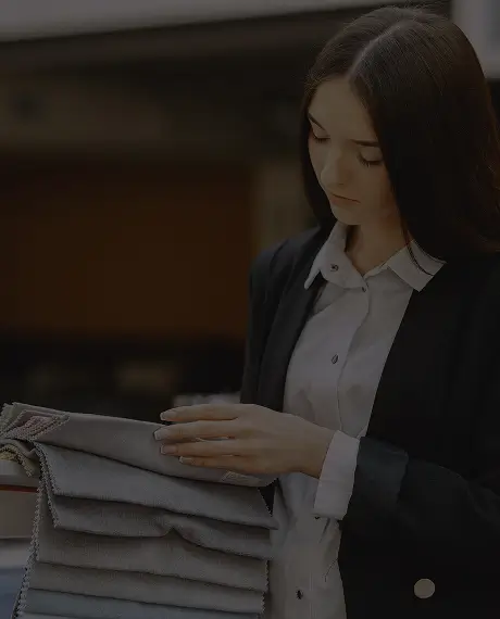 Woman examining fabric swatches indoors