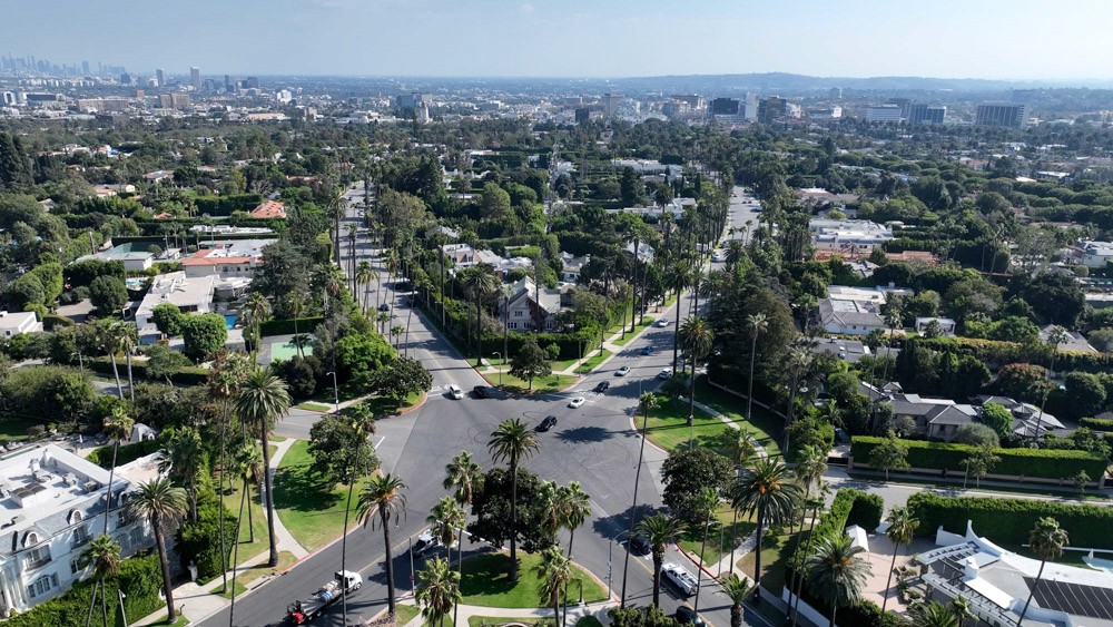 a group of people sitting around a table with laptops