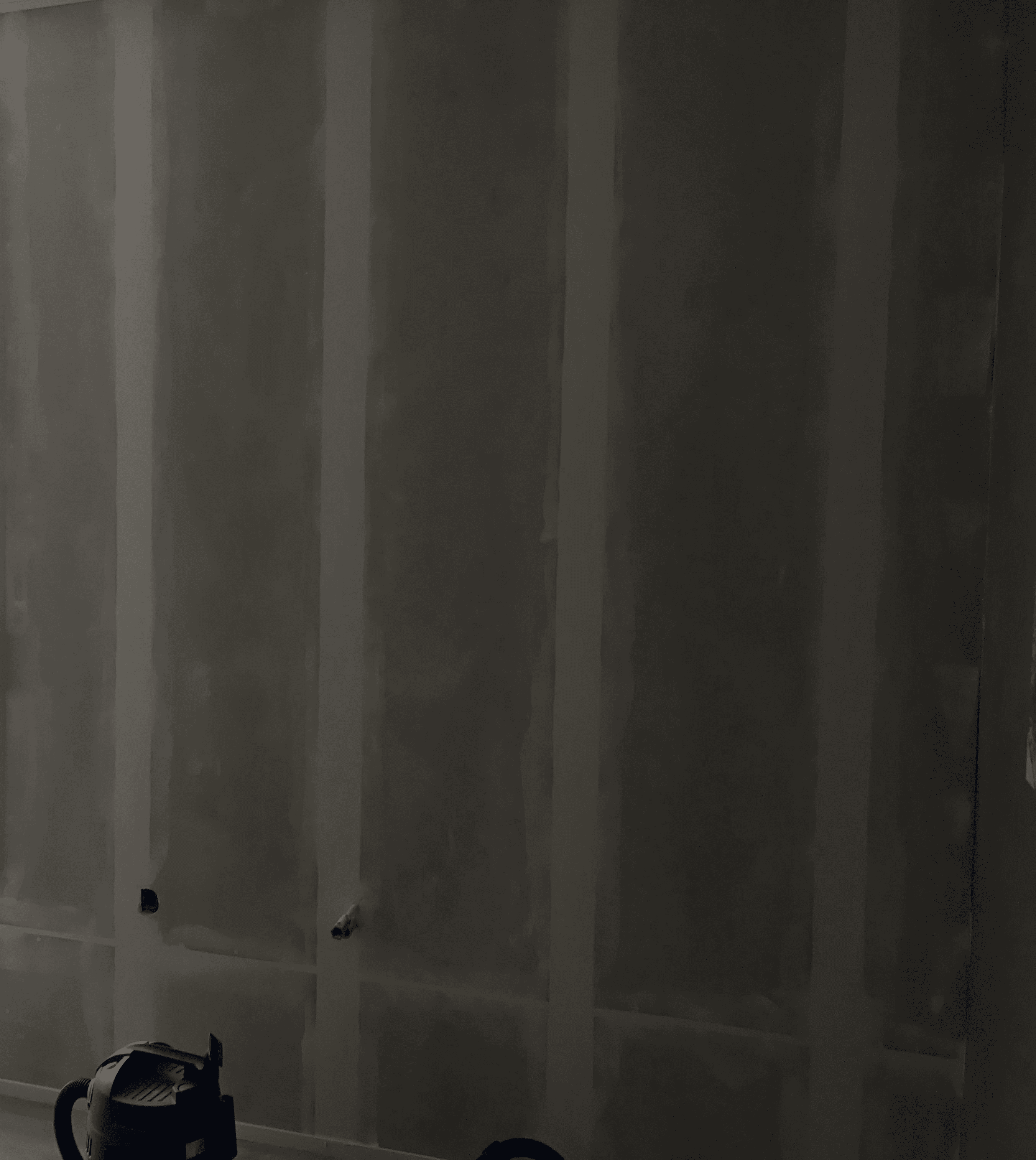 woman holding a phone and man looking at the phone. both are smiling