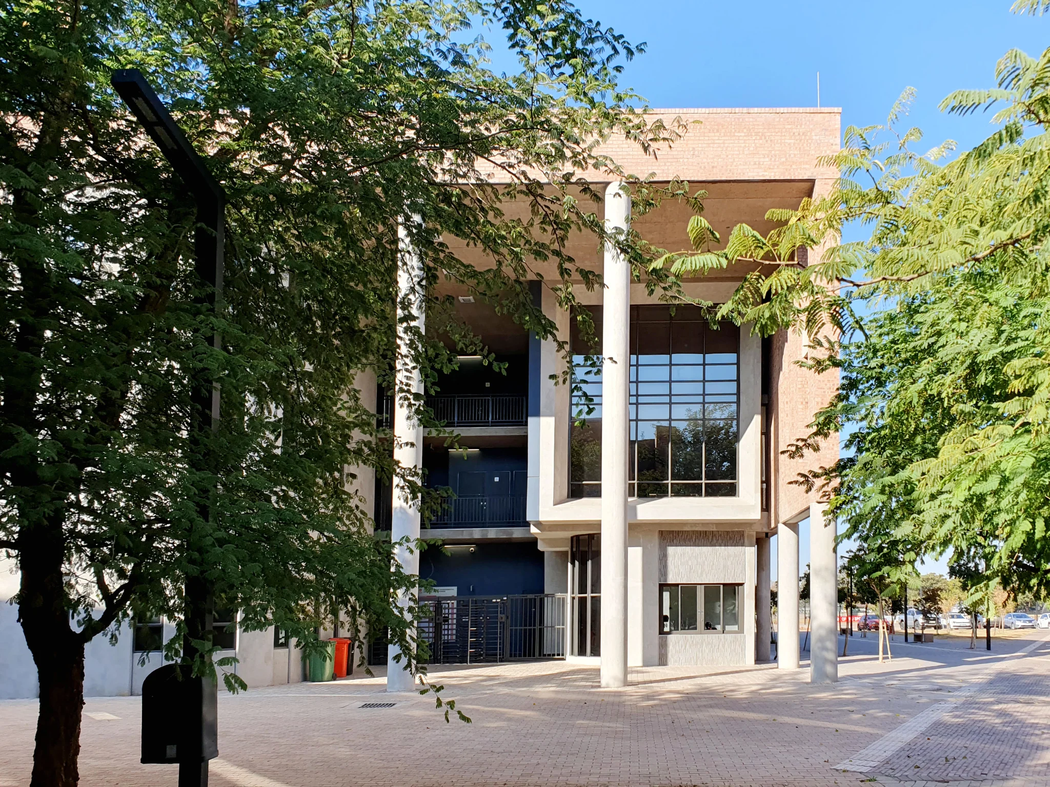 Sol Plaatje University science building brick entrance shaded by trees.