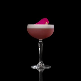 A closeup of a Rose Orchard drink against a dark background.