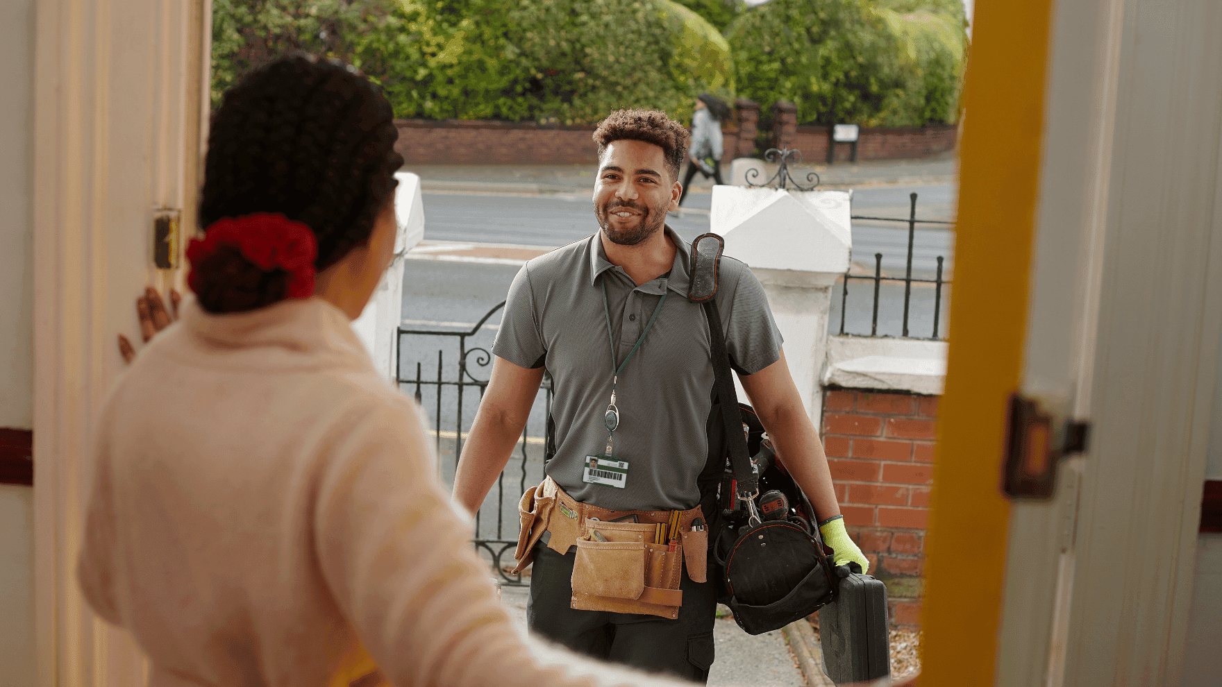 A smiling handyman arriving at a client's door - perfect for depicting the image  "starting a handyman business in Ontario."