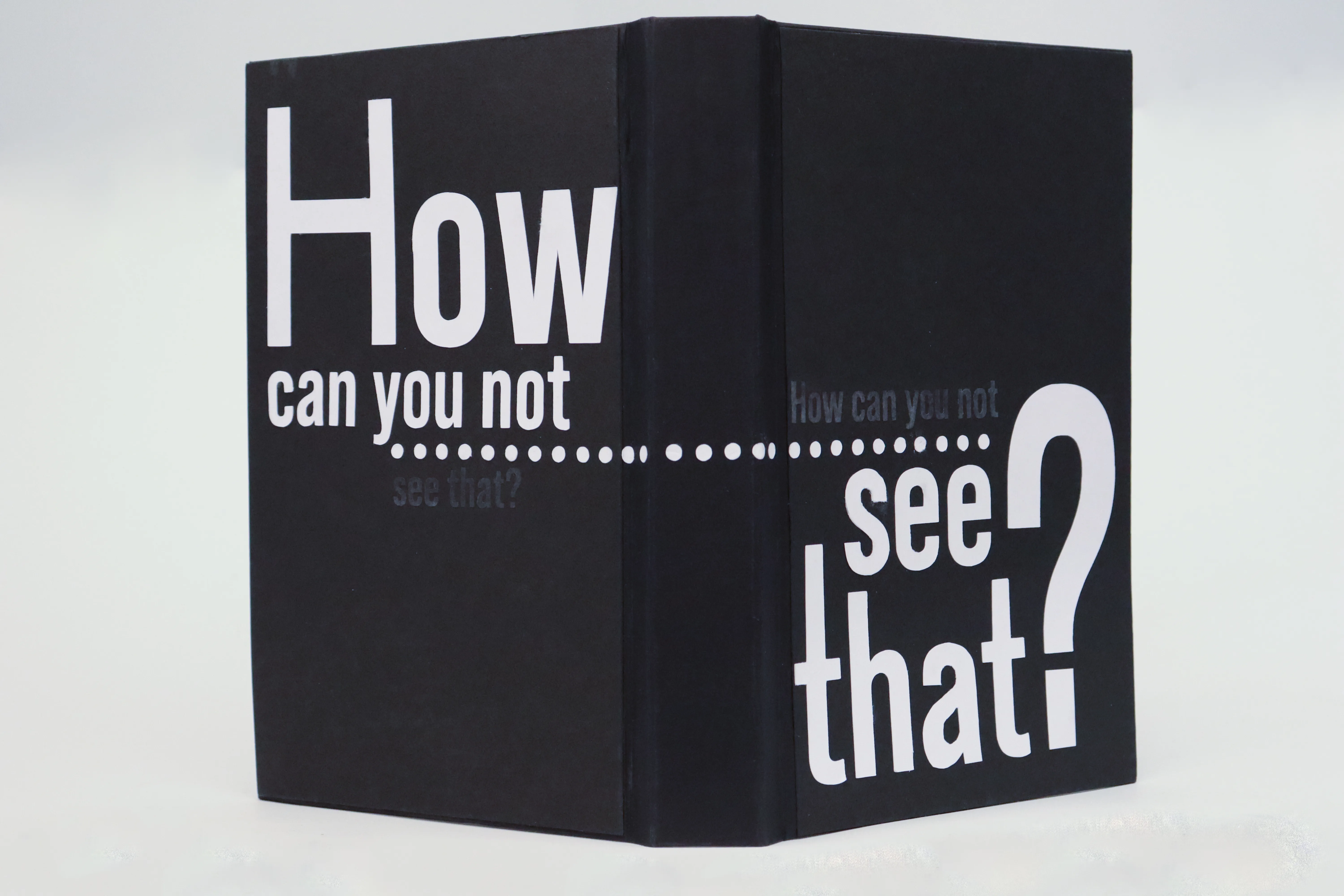 Open cover from behind, highlighting "How can you not" on the back cover and "see that?" on the front cover