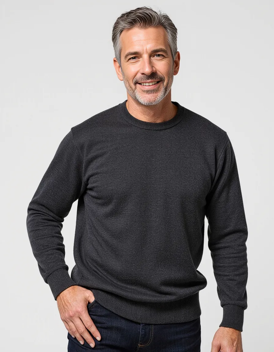 Professional portrait featuring a person with silver hair wearing a dark sweater against a white background, showcasing clean studio lighting.