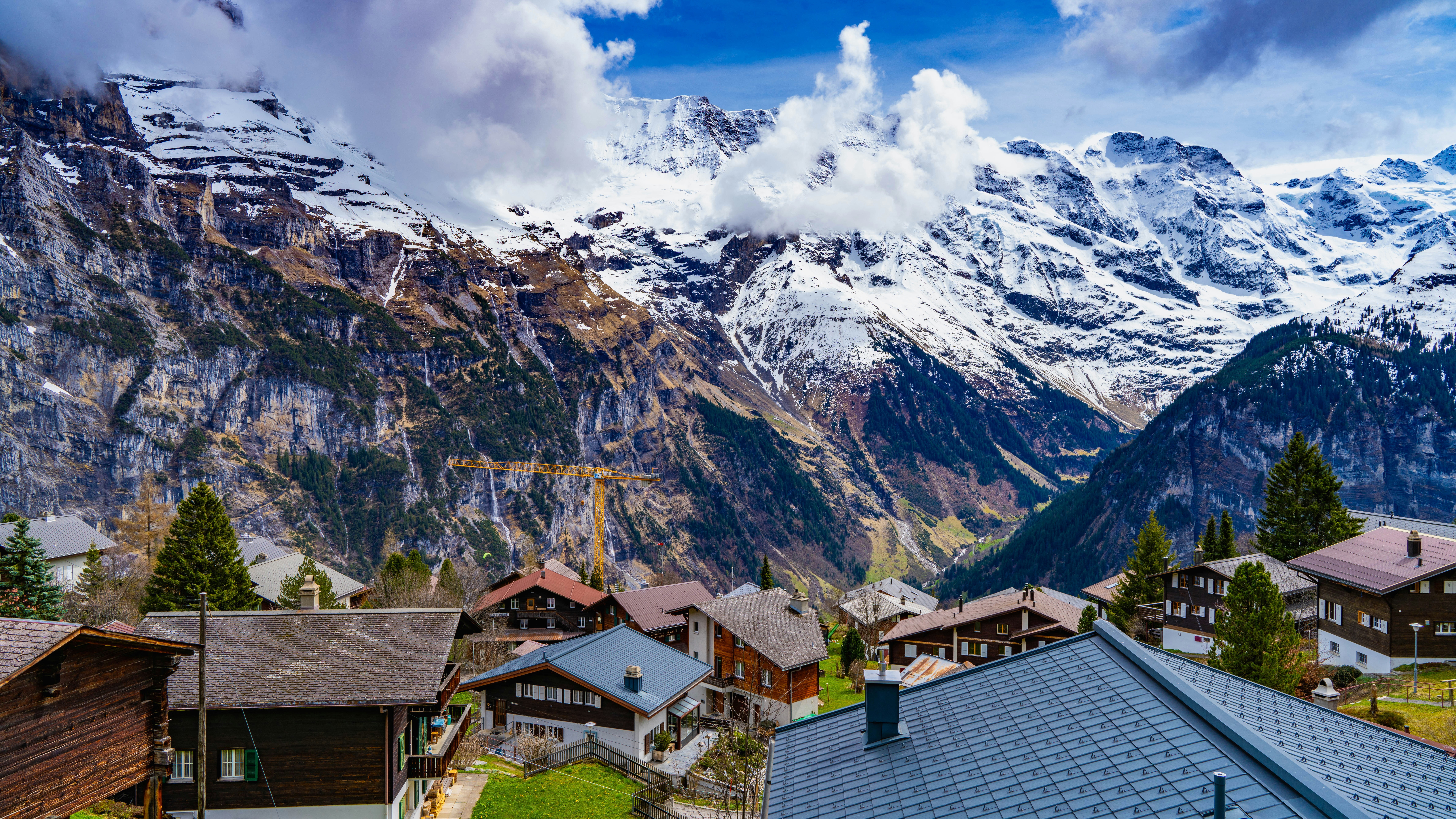 a view of a mountain range with houses in the foreground