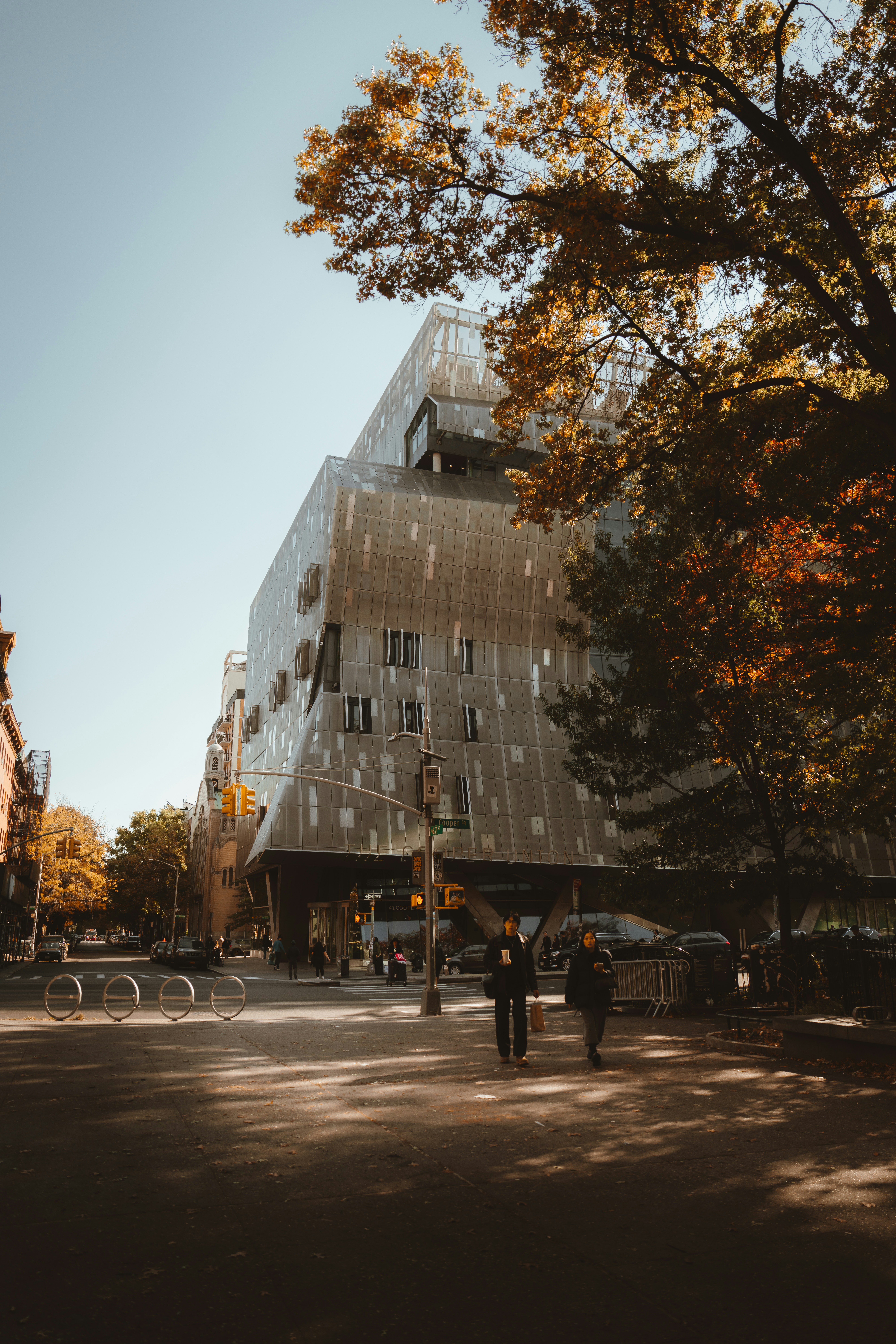 Modern building on a city street with autumn trees