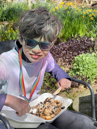 Gabriel eating a waflle after the colour run