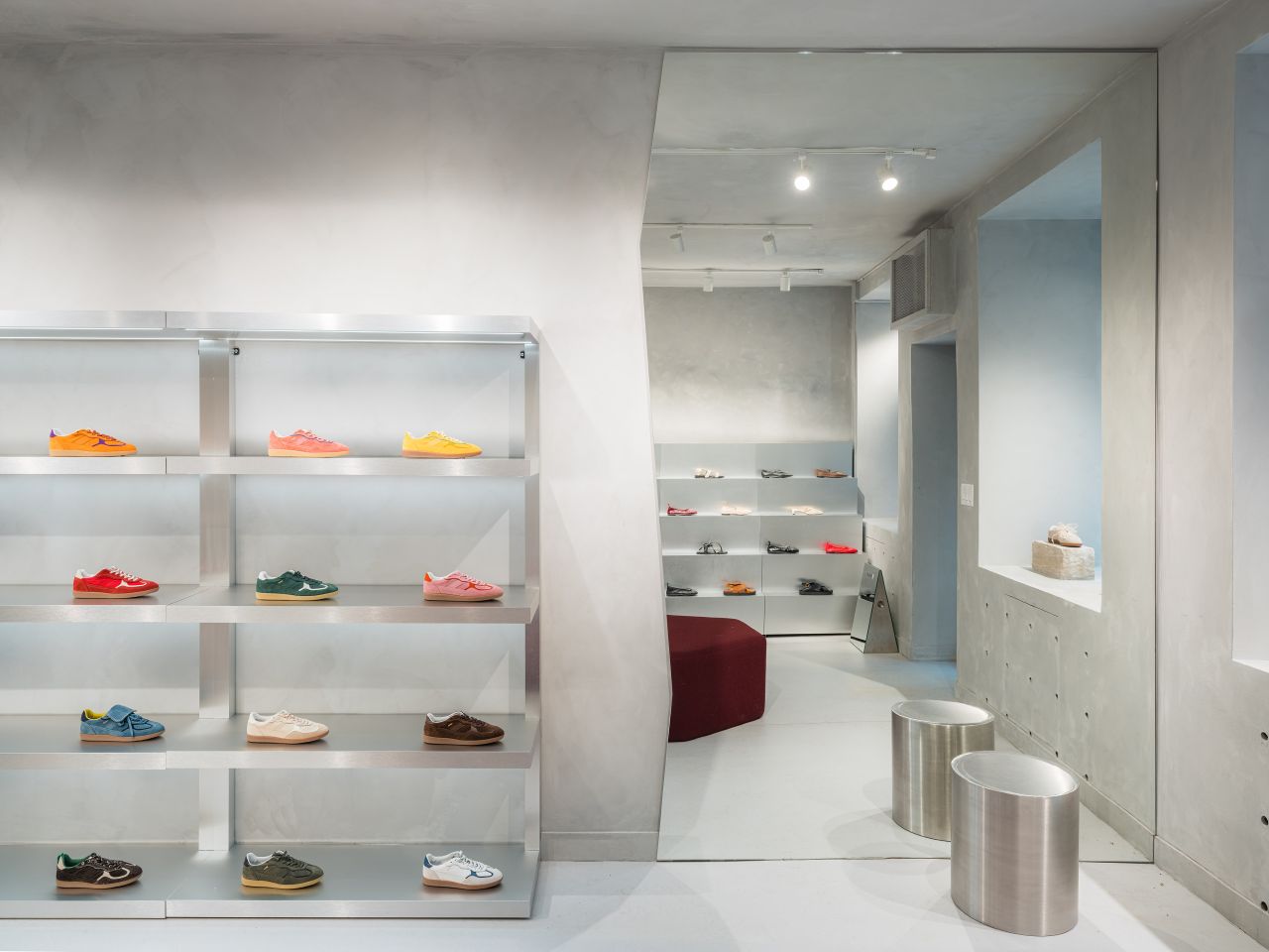 Interior view of the Alohas New York retail store showing minimalist shelving, sculptural seating, and an open layout designed to guide customers through the space.