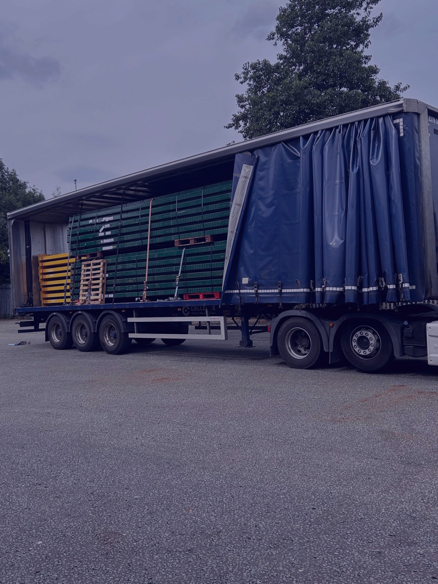 Image of an artic lorry with its curtains open and carrying components for racking inside