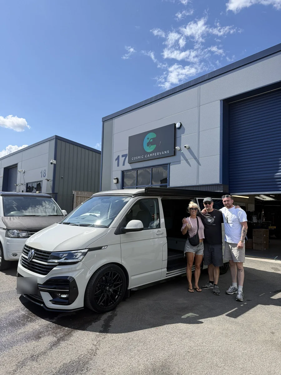 Customers collecting their Ascot Grey campervan outside the Cosmic workshop