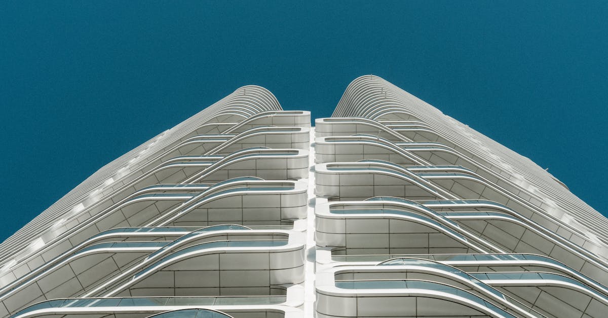 Stunning view of a modern architectural building with sleek glass and steel facade against a clear b