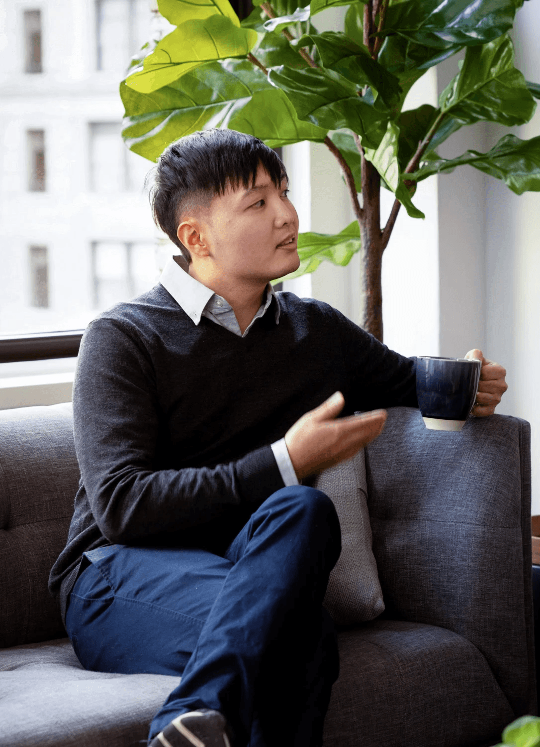 Therapist and client in conversation during an LGBTQ affirming therapy session at Expansive Therapy office in New York, featuring a calm, modern space with natural light and plants.