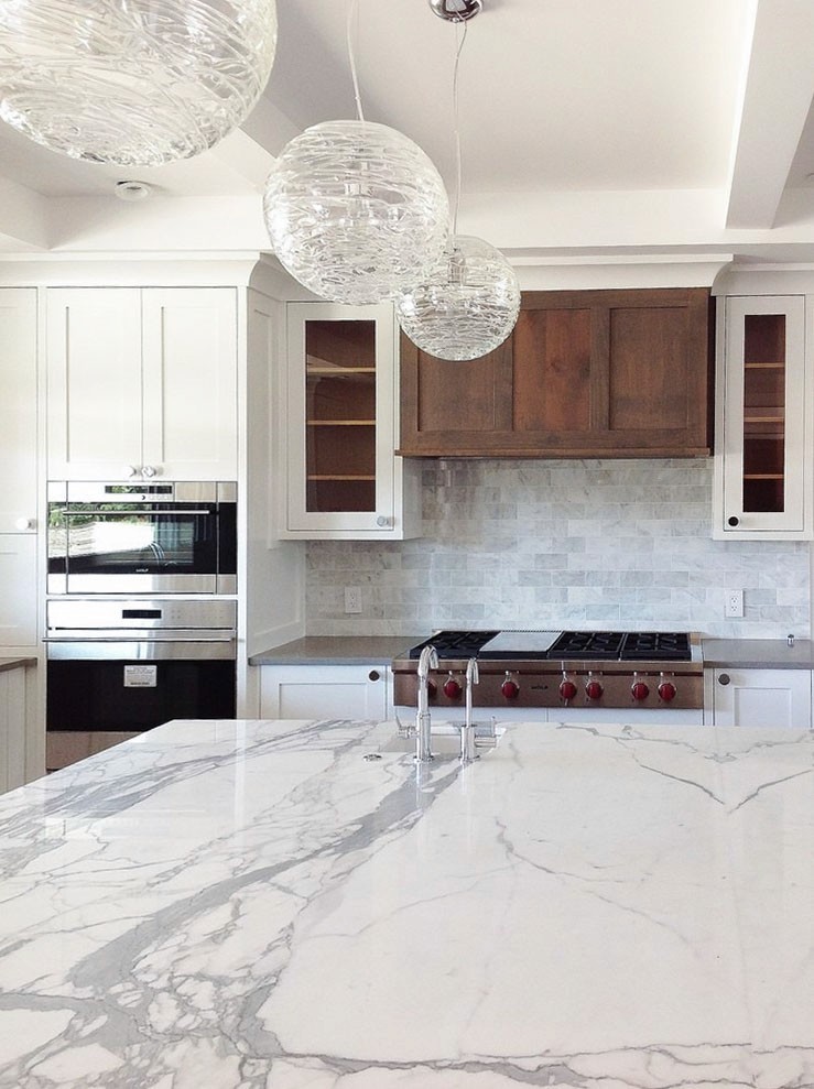 Image of Luxury kitchen design with marble island, custom cabinetry, and modern appliances by KHD Homes.